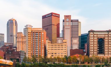 Pittsburgh skyline at sunset with reflection in the water, how to save on pennsylvania car insurance blog