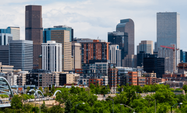 Skyscrapers in Denver on a cloudy day, how to save on Colorado car insurance blog