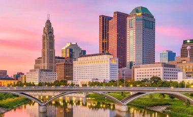 Columbus skyline background for ohio car insurance laws guide