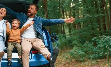 family waiting for electric car to charge outdoors insured with family car insurance